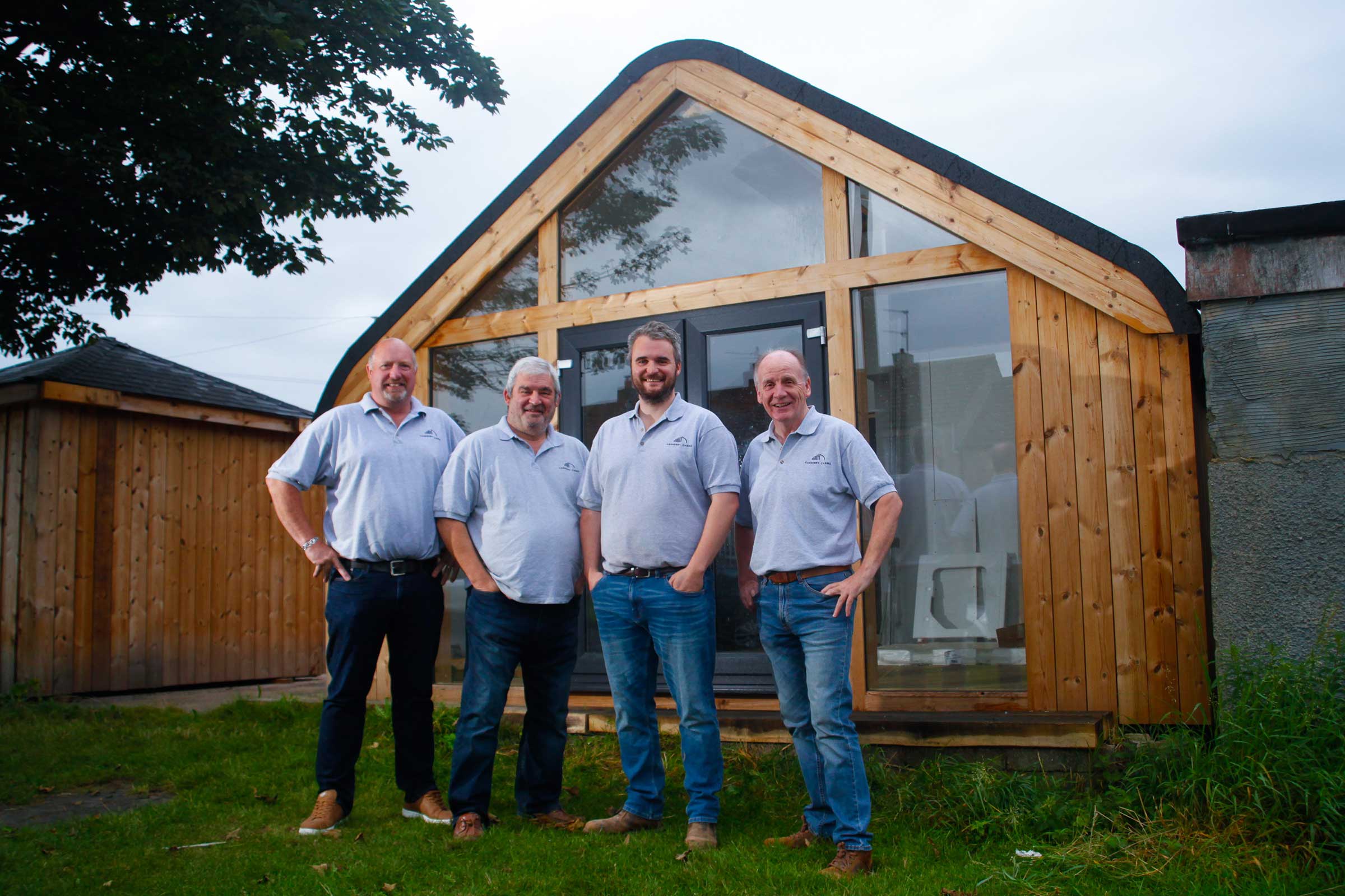 carberry® cabins team in front of timber cabin